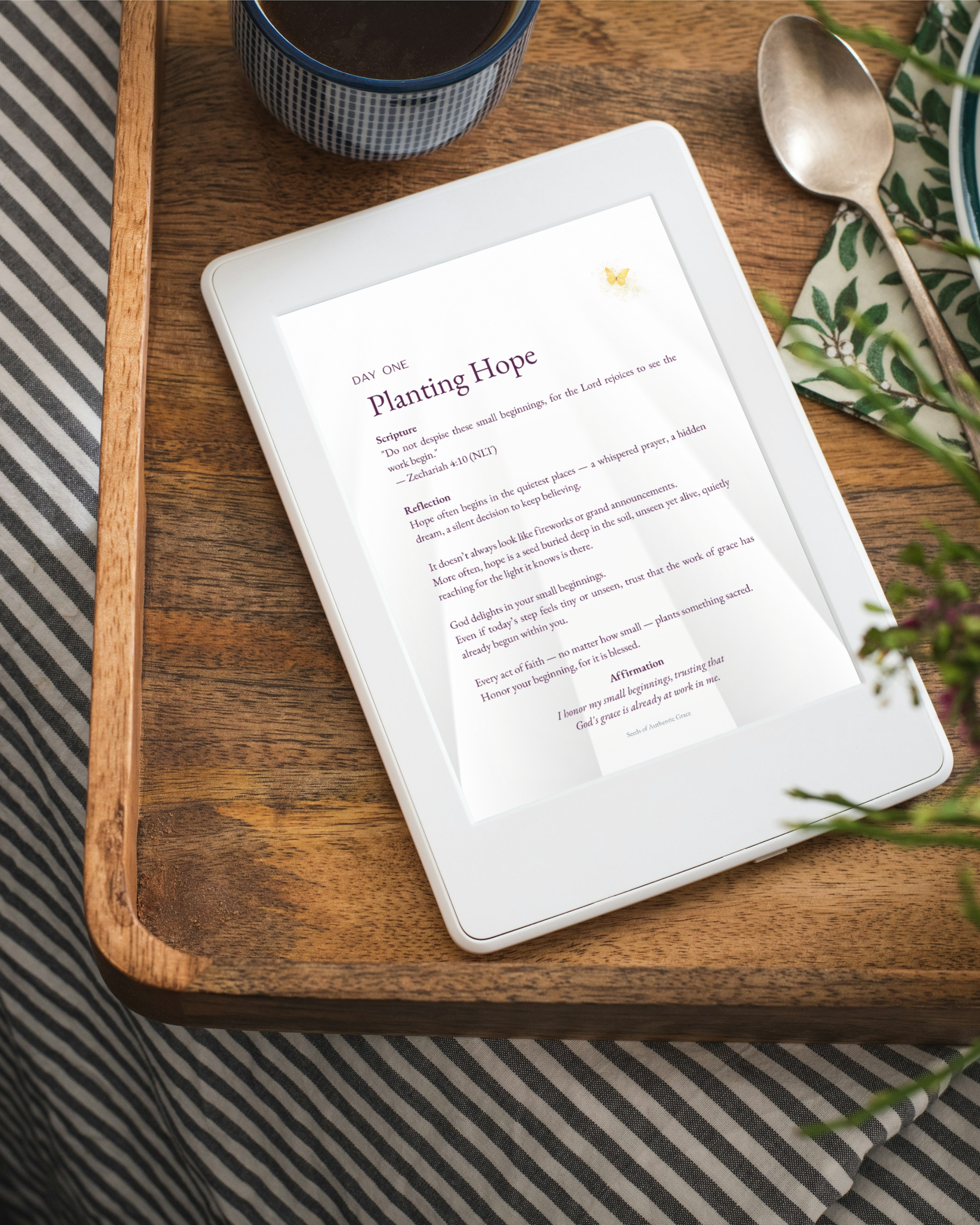 Day One page titled Planting Hope from Seeds of Authentic Grace devotional displayed on tablet beside coffee cup and spoon on wooden tray.