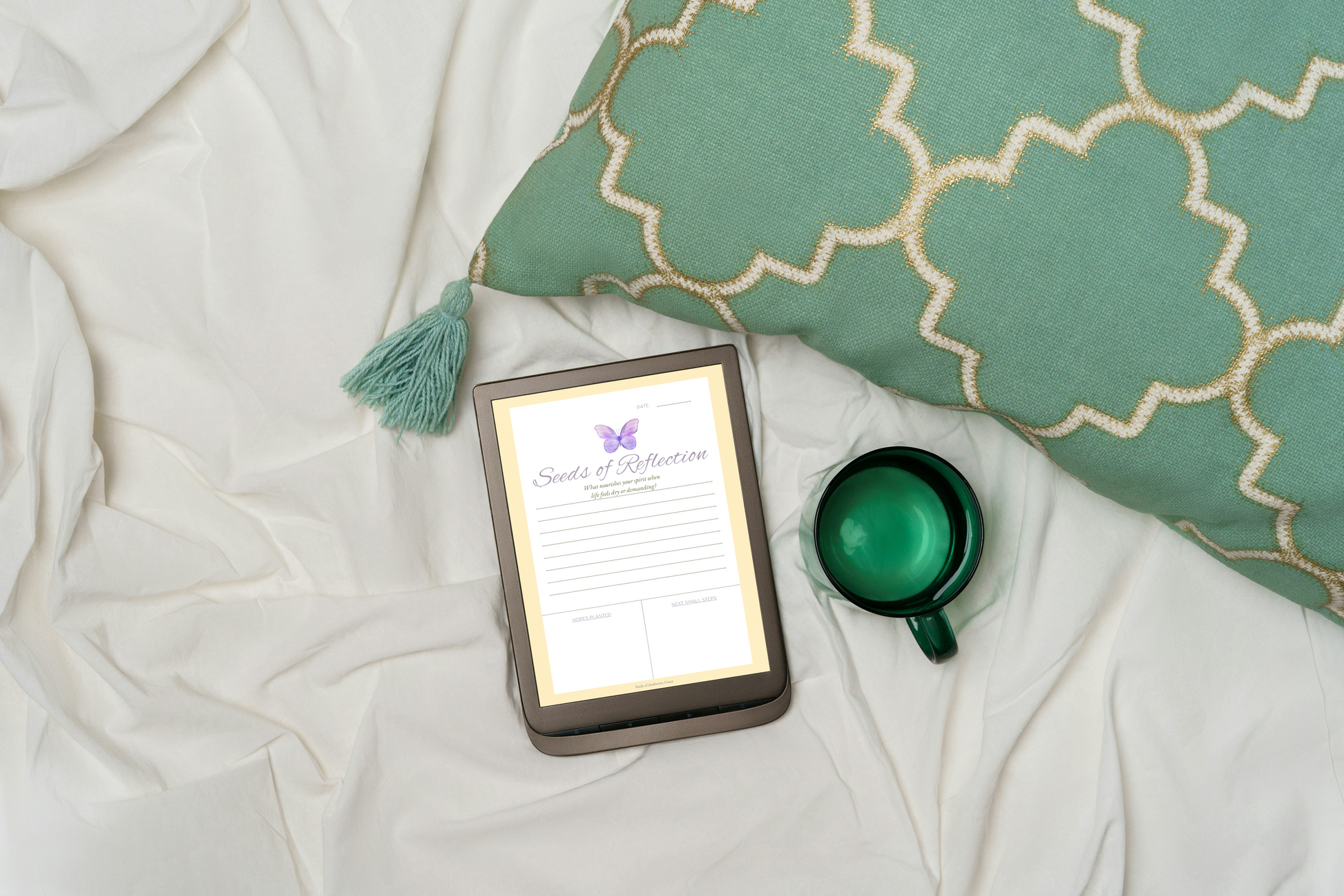 Seeds of Reflection page from Seeds of Authentic Grace devotional displayed on tablet with green pillow and coffee cup on white linen background.